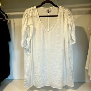 Beautiful white top that goes with jeans or to the office.